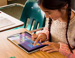 Girl using Microsoft Surface tablet in classroom